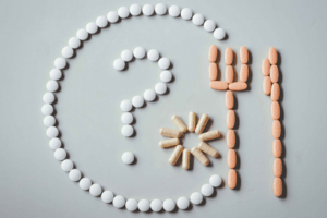 supplements, pills and tablets arranged in a plate pattern